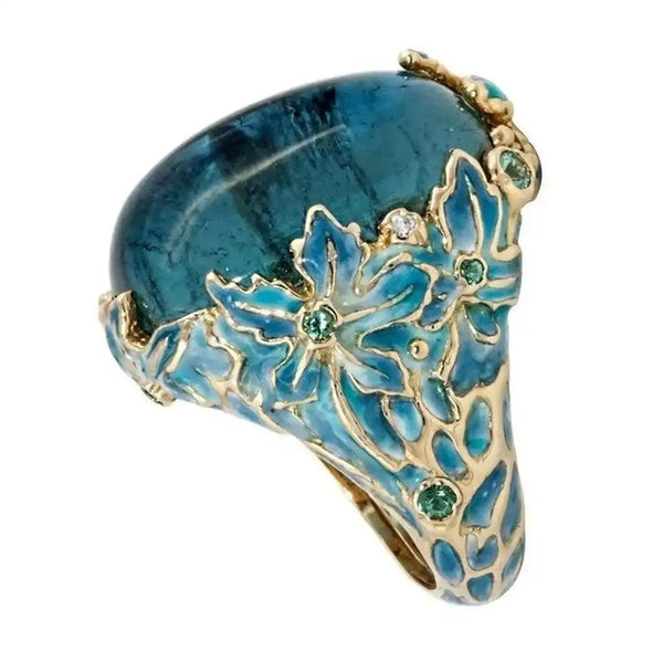 Bague en pierre bleue avec fleur dorée élégante