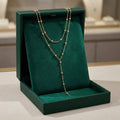 Collier long à pompons en double couche doré
