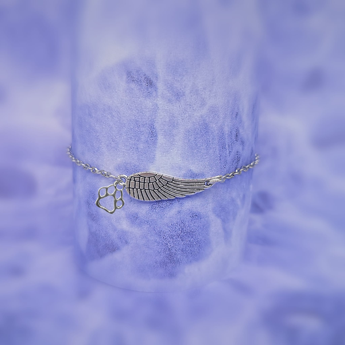 Bracelet souvenir argenté avec une aile d'ange et une patte, fait à la main
