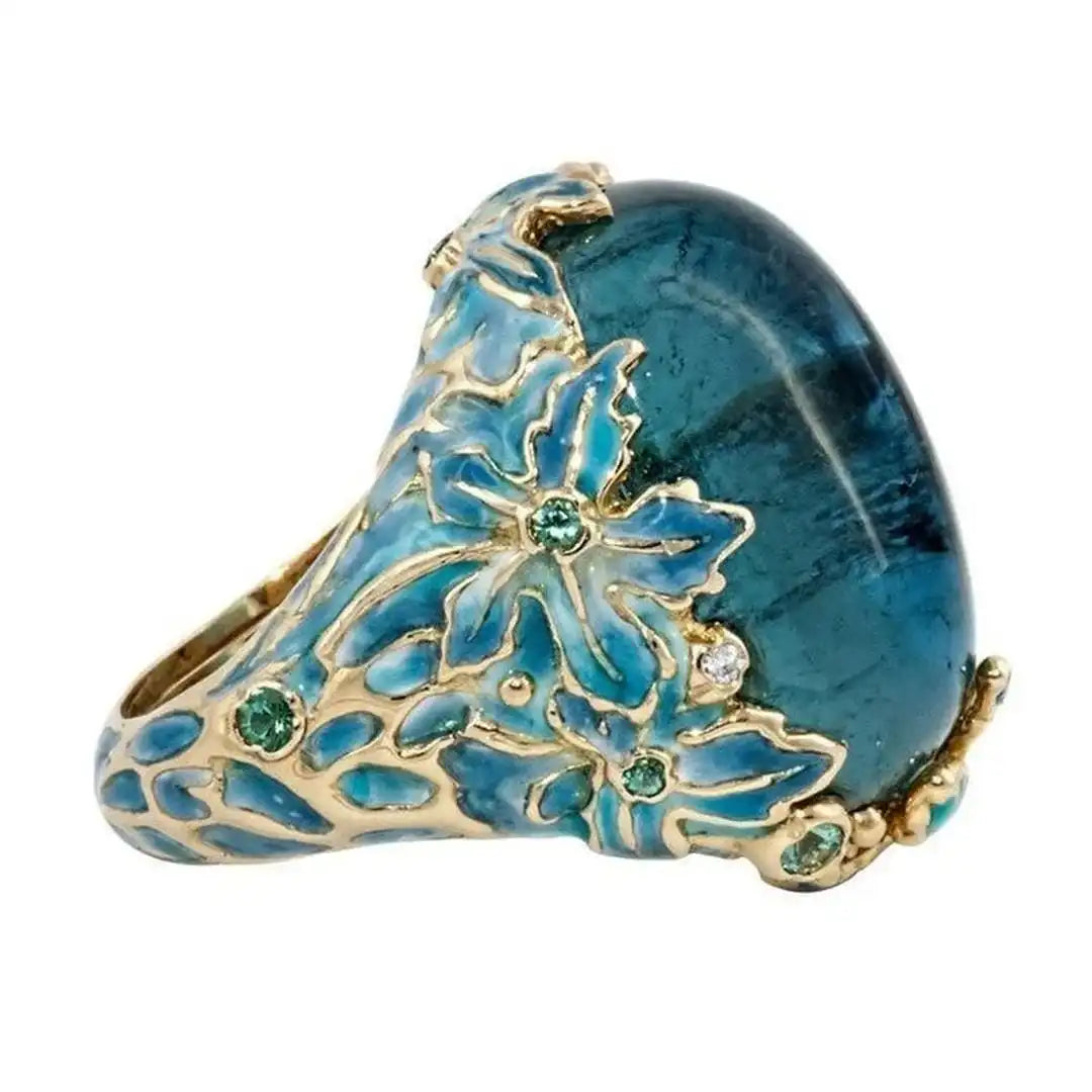 Bague en pierre bleue avec fleur dorée élégante