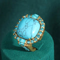 Bague en zirconium avec pierre turquoise dorée