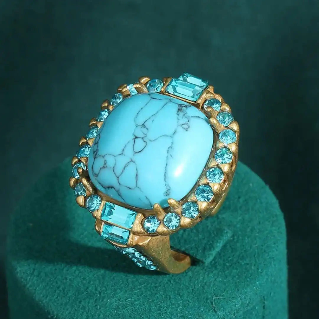 Bague en zirconium avec pierre turquoise dorée