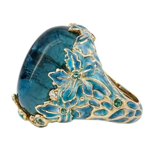 Bague en pierre bleue avec fleur dorée élégante
