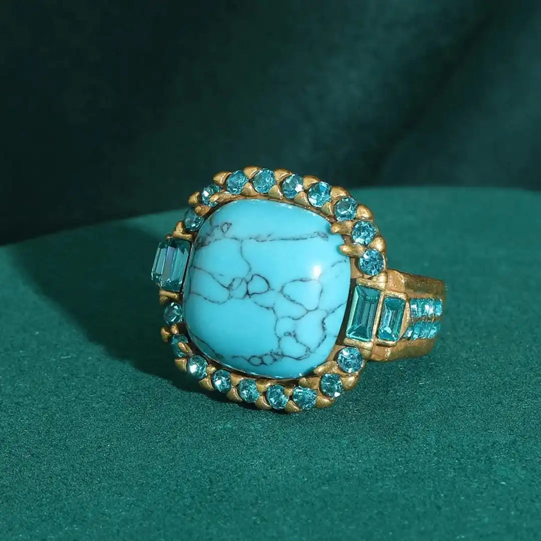 Bague en zirconium avec pierre turquoise dorée