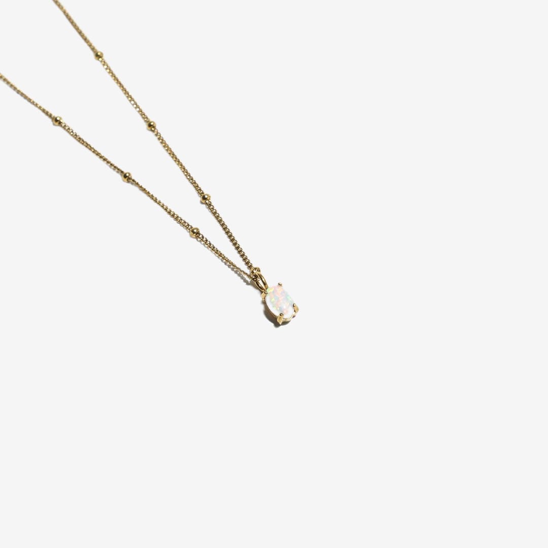 Collier en perles dorées avec pendentif en opale