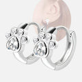 Boucles d'oreilles en forme de patte avec des zircons scintillants